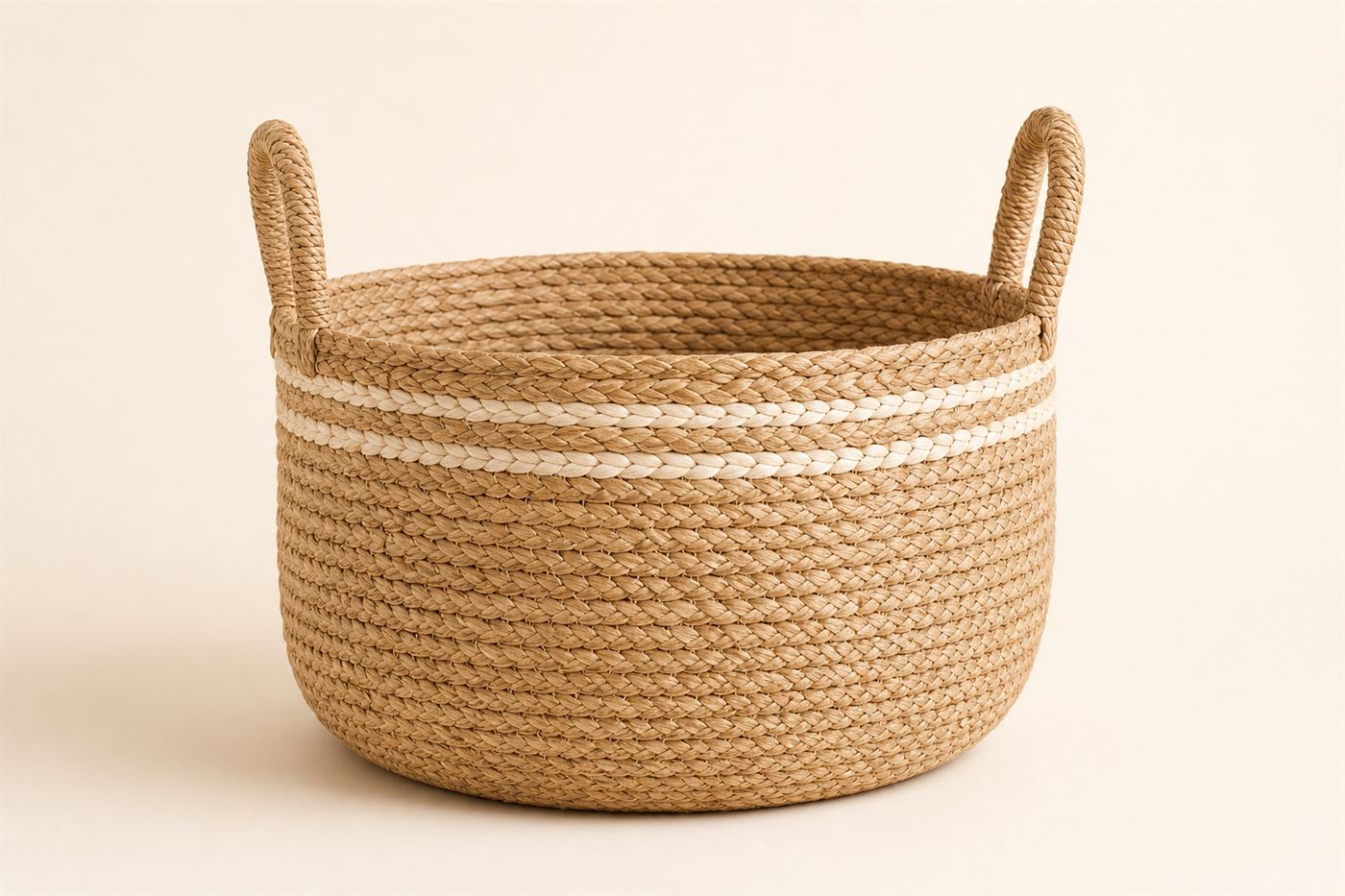 Round banana-fiber basket with handles and cream stripe